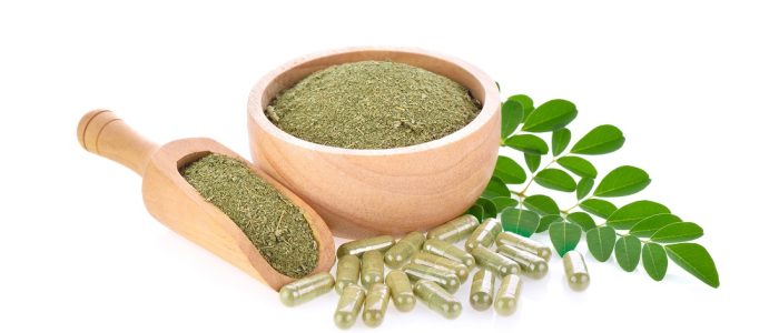 moringa leaf and powder on white background